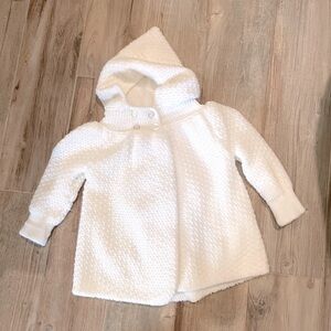 Beautiful new infant sweater cape in cream. Infant size.